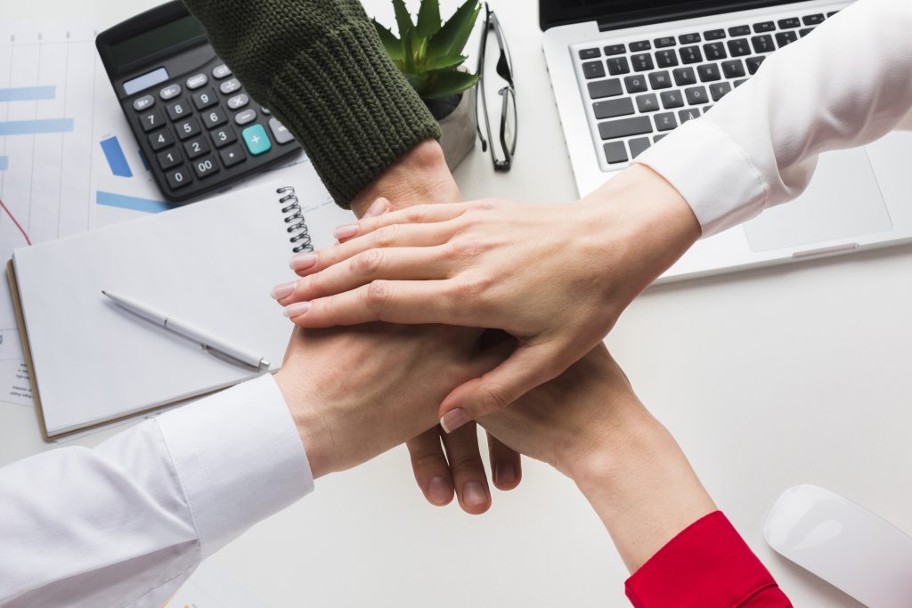 top view hands together work desk
